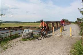 Marjorie Foote and Philip McGranahan of Kittery bike through Scarborough Marsh on Aug. 14, 2012, as they follow the East Coast Greenway from Portland to Saco.