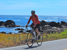 Cyclist riding near the ocean