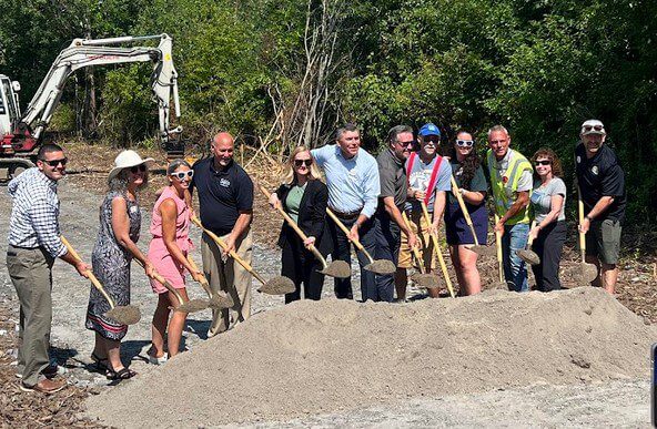 Group groundbreaking with shovels.